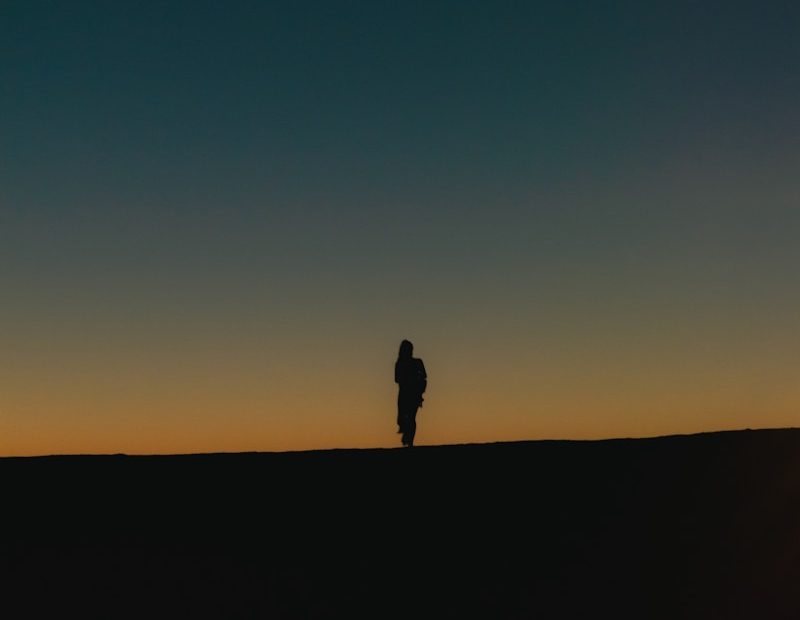 silhouette of person standing on black surface